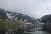 kareri lake with snow covered mountains 