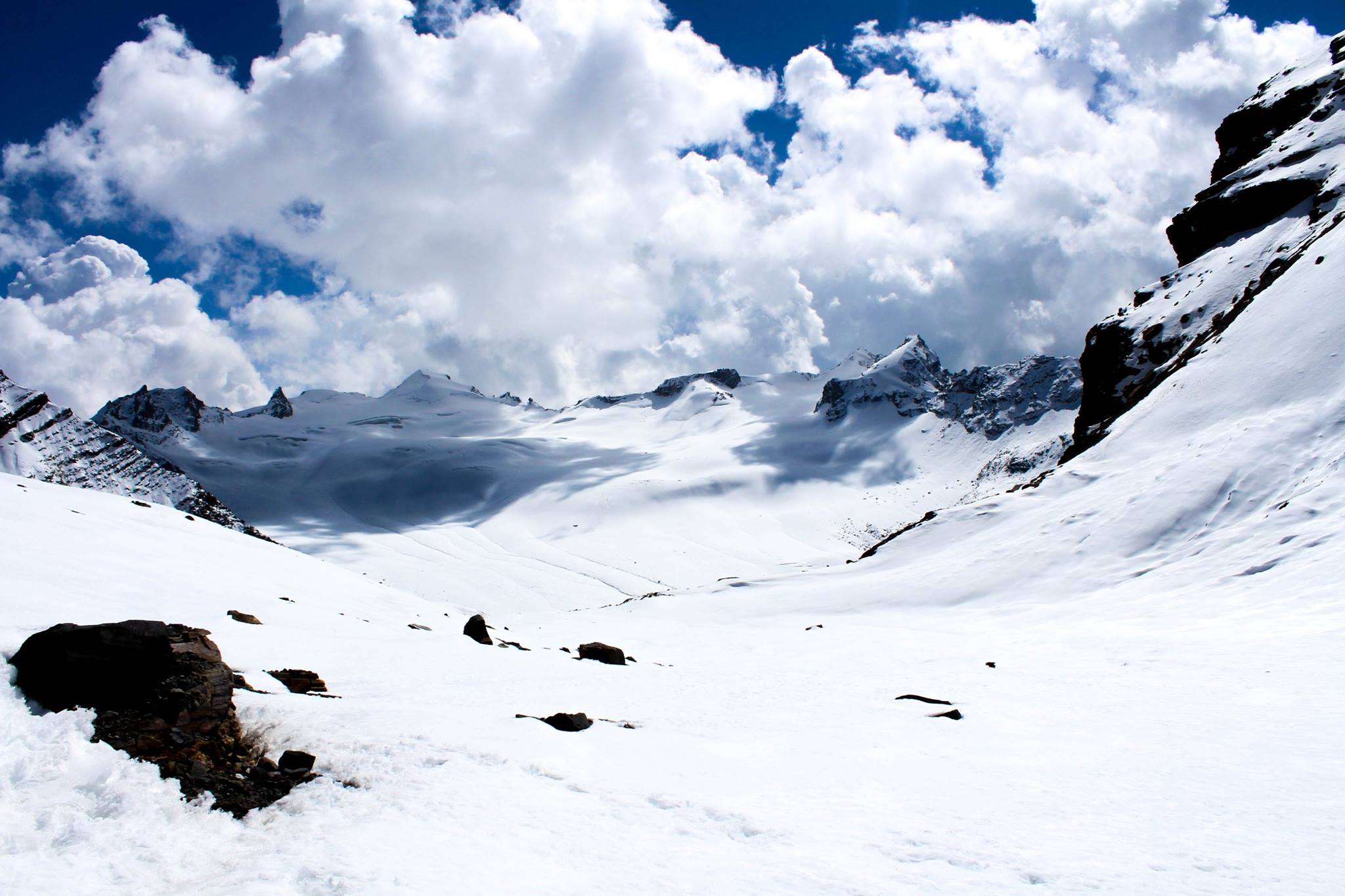 clouds hovereing over the snow covered mountains with bule sky, enroute pin valley