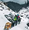 trekkers walking on snow enroute prashar lake