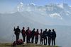 trekkers posing for camera with their back facing mountain nandakot