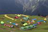 tents of different colour pitched on bedni bugyal campsite
